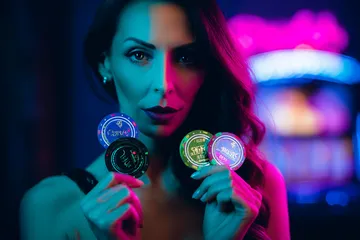A woman smiling by bright slot machines showing lucky symbols, showcasing the exciting slot offerings at BD9.